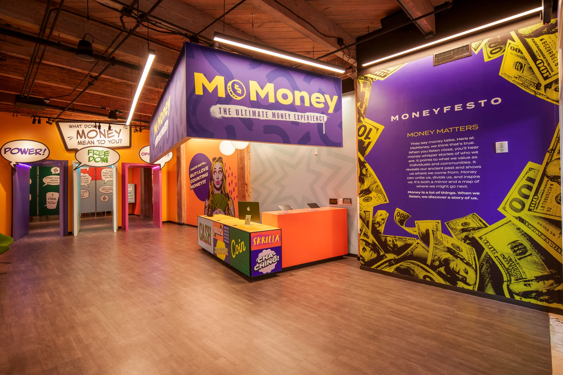 Lintshiwe's lobby: purple signage above an orange reception desk, with speech-bubble doorways and the Moneyfesto wall.